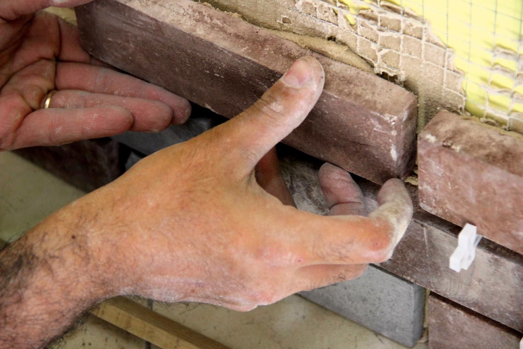 Close-up of a mason repointing brick joints in Cleveland